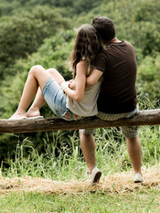 couple cuddling on bench